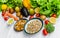 Fresh fruit and vegetables, grains, and nuts on a white background.