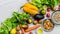 Fresh fruit and vegetables, grains, and nuts on a white background.