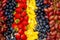 Fresh fruits background, Arrangement in row of grapes assorted berries and slice pineapple