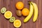 Fresh fruits banana, kiwi, orange isolated on wooden background. Healthy food. A mix of fresh fruit. Group of citrus fruits.