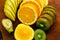 Fresh fruits banana, kiwi, orange on wooden background. Healthy food. A mix of fresh fruit. Group of citrus fruits. Vegetarian raw