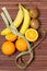 Fresh fruits banana, kiwi, orange wrapped in a centimeter, isolated on wooden background. Healthy food. Fitness motivation.