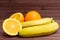 Fresh fruits banana, orange isolated on wooden background.