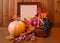 Fresh fruits in basket, pumpkin and picture frame