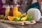 Fresh fruits and juice bottle on table. Food and drink concept. Healthy food and vitamins c theme. Crowd people in background