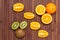Fresh fruits kiwi, orange isolated on wooden background. Healthy food. A mix of fresh fruit. Group of citrus fruits.