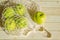 Fresh fruits in a mesh bag. Top view, apples in a string bag on a wooden background