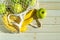 Fresh fruits in a mesh bag. Top view, bananas and apples in a string bag on a wooden background