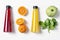 Fresh fruits in raws with juice bottles on white background. Red, orange, yellow and green. Food ingredients