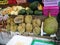 Fresh fruits on the shelves of a street vendor kiosk on a street in Thailand