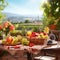 Fresh fruits on the table. A beautiful view on fields and mountains from patio on a sunny day