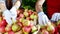 Fresh fruits from the tree in the apple orchard workers selecting the apples from the wooden box they wearing protective