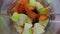 Fresh fruits vegetables chopping in blender super slow motion close up top view.