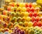 Fresh fruits and vegetables cutted into pieces in plastic cup, close up view. Multicolour fruits background. Selective