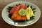 Fresh fruits on white plate with natural banana leaf arrangement. Cut Healthy fruits, papaya, watermelon, pineapple on a plate.