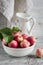 Fresh garden apples in a white bowl, vintage enameled pitcher