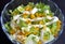Fresh garden salad with yellow peppers and green onion and creamy ranch dressing