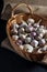 Fresh garlic in a basket on burlap on a black table.