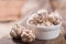 Fresh garlic in a small bowl on wooden background