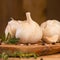 Fresh garlic with spices on a wooden background, thyme and rosemary. Culinary background, ingredients for marinade, close up.