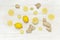 Fresh ginger root and lemon on white wooden background. Flat lay, top view, copy space. Minimalistic style, seasoning, spice,