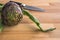 Fresh globe artichoke on wood background with knife