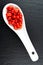 Fresh goji berries in a white porcelain spoon