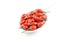 Fresh goji berries in a white porcelain spoon isolated on a white background