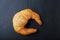 Fresh golden croissant on dark background