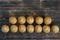 Fresh golden cupcakes with letters lie on a wooden rustic table made of pine boards. Bon appetite