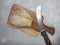 Fresh golden needle mushroom or enoki mushrooms, on wooden cutting board with vintage knife on gray concrete background