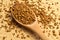 Fresh granules of instant coffee grains, in wooden spoon, on wooden background