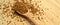 Fresh granules of instant coffee grains, in wooden spoon, on wooden background