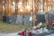 Fresh grave of recently deceased person. Visible memorial stand for the picture and a brown wooden cross. Idyllical autumn setting