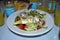 Fresh Greek salad on a white plate, Glyfada, Athens