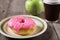 Fresh green apple, donut and take away coffee, wooden background with copy space