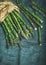 Fresh green asparagus in craft paper bag, copy space