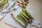 Fresh green asparagus on cutting board. Preparing asparagus for cooking: washing and peeling.