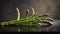 Fresh green asparagus spears on a black background with water drops