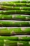Fresh green asparagus vegetable stems in a row pattern closeup. Vegan summer season food plant.