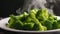 Fresh green broccoli on a white plate with smoke on a dark background