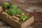 Fresh green broccoli in wood bowl over rustic wooden background healthy or vegetarian food concept Top view