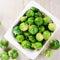 Fresh Green Brussels Sprouts on White Bowl