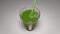 Fresh green celery juice in glass with straw. Antioxidant vegan plant based diet for cleansing body and weight loss