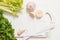 Fresh green celery stems on wooden cutting board closeup. celery parsley and garlic. cooking food. Copy space, top view