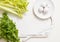 Fresh green celery stems on wooden cutting board closeup. celery parsley and garlic. cooking food. Copy space, top view