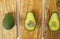 Fresh green cutted avocados on olive wood