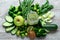 Fresh green food on a light table. Avocados cucumbers cabbage apples beans kiwi onions broccoli. The concept of healthy food,