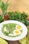 Fresh green herbs soup with eggs