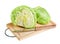 Fresh green iceberg lettuce with knife on board